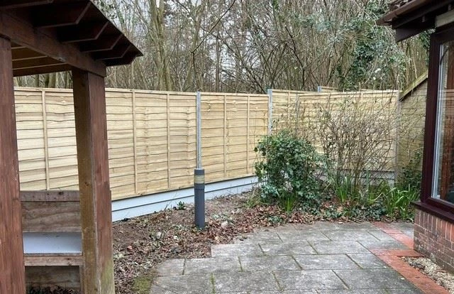 Larch-lap fencing around care-home patio are
